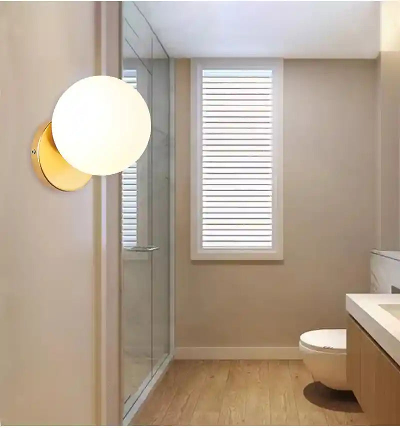 Bathroom interior with a wall-mounted light fixture.