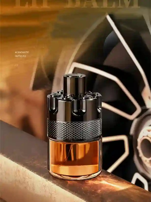 Black and silver perfume bottle with brown liquid on a metallic surface