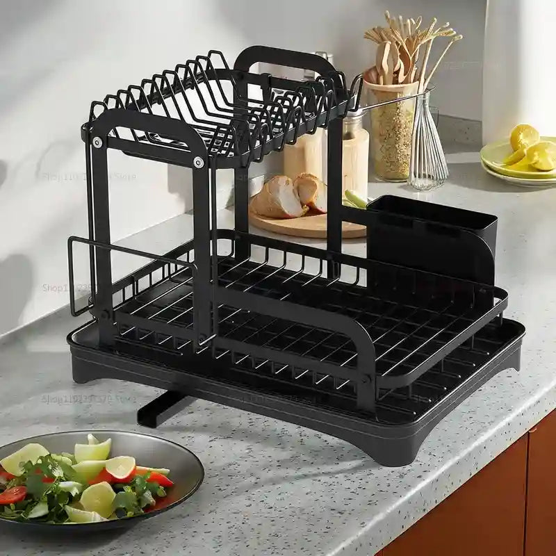 Black dish rack on a kitchen counter with various items around