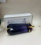 Black electronic device with gold accents on a white surface, branded 'MUTT'.