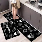 Black kitchen mats with white coffee-themed designs on a wooden floor.