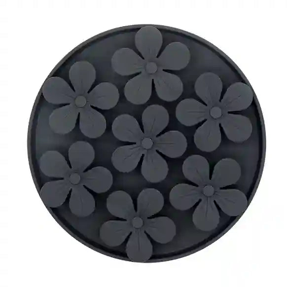 Black silicone mold with flower shapes on a white background