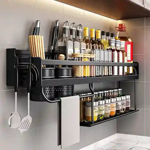 Black wall-mounted kitchen shelf with various kitchen items on a tiled wall.