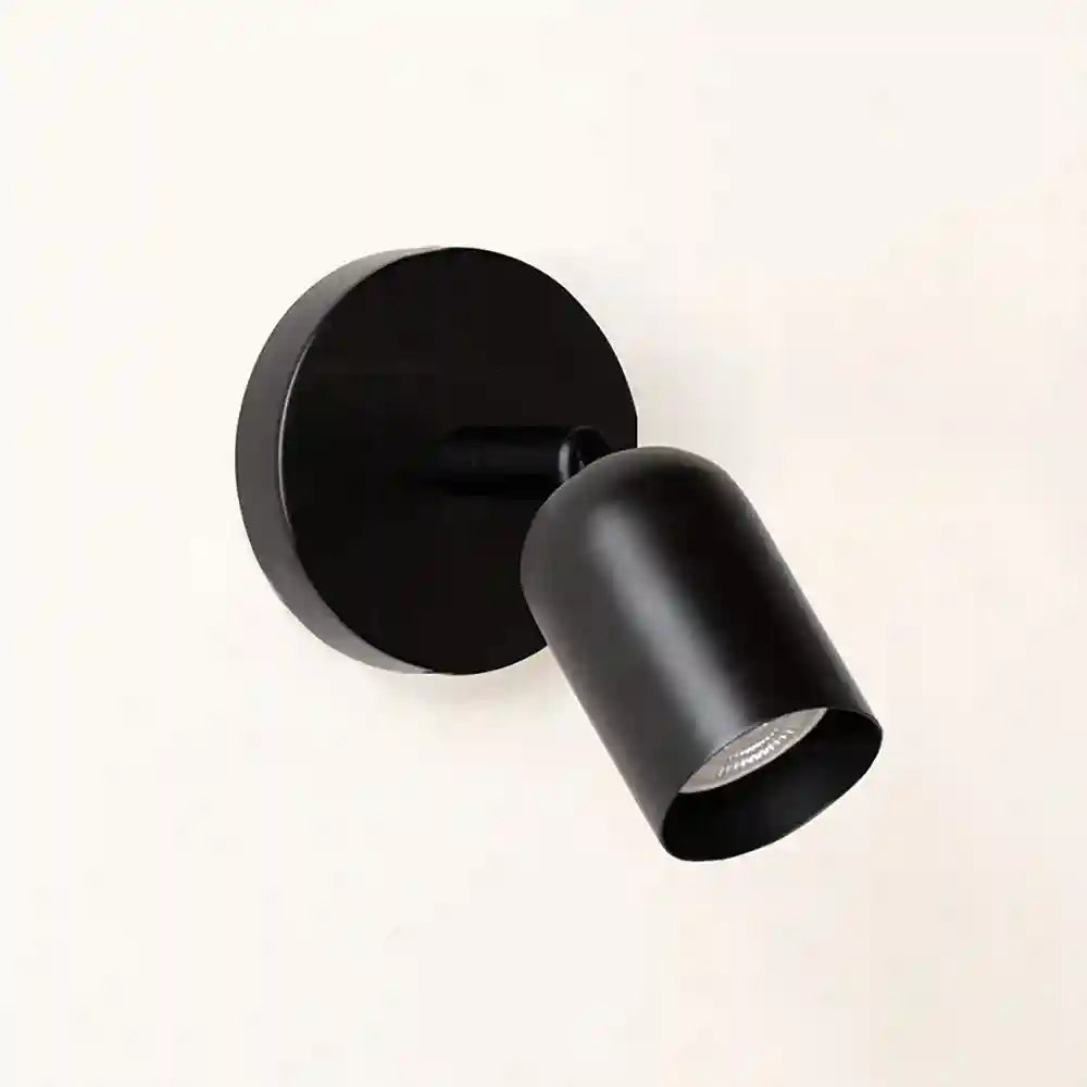 Black wall-mounted light fixture on a white background