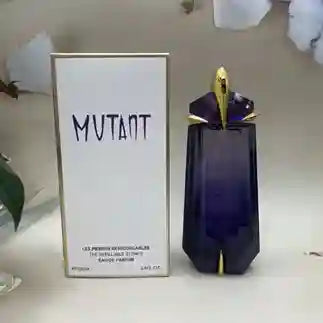 Blue perfume bottle with gold cap and 'Mutant' packaging on a white surface.