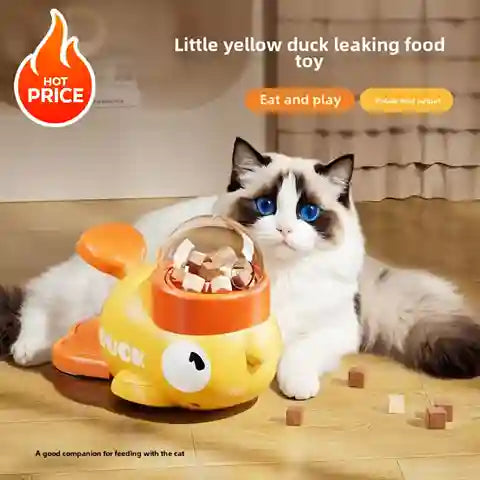 Cat playing with a yellow duck-shaped food toy on a wooden floor.