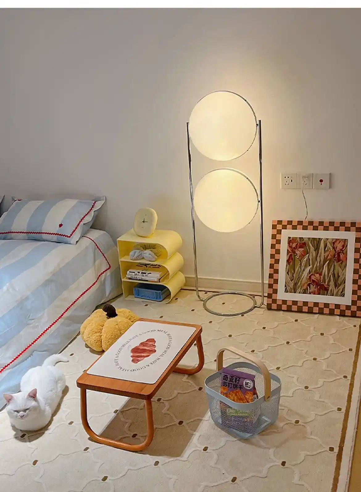 Children's room with a bed, lamp, and toys on a light-colored floor.