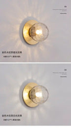 Two wall lights with gold fixtures and glass shades on a white background.