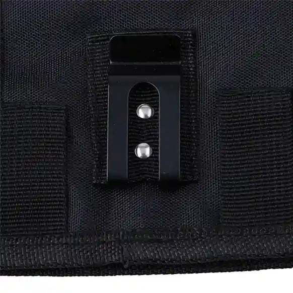 Close-up of a black tactical pouch with a clip on a black background