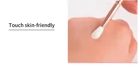 Close-up of a hand holding a small applicator with text 'Touch skin-friendly' on a white background