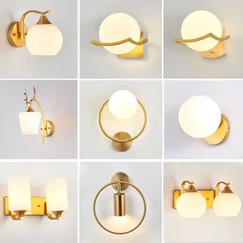 Collection of gold wall sconces with white glass shades on a light gray background