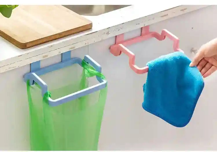 Colorful hooks on a kitchen counter holding a trash bag and a blue cloth.