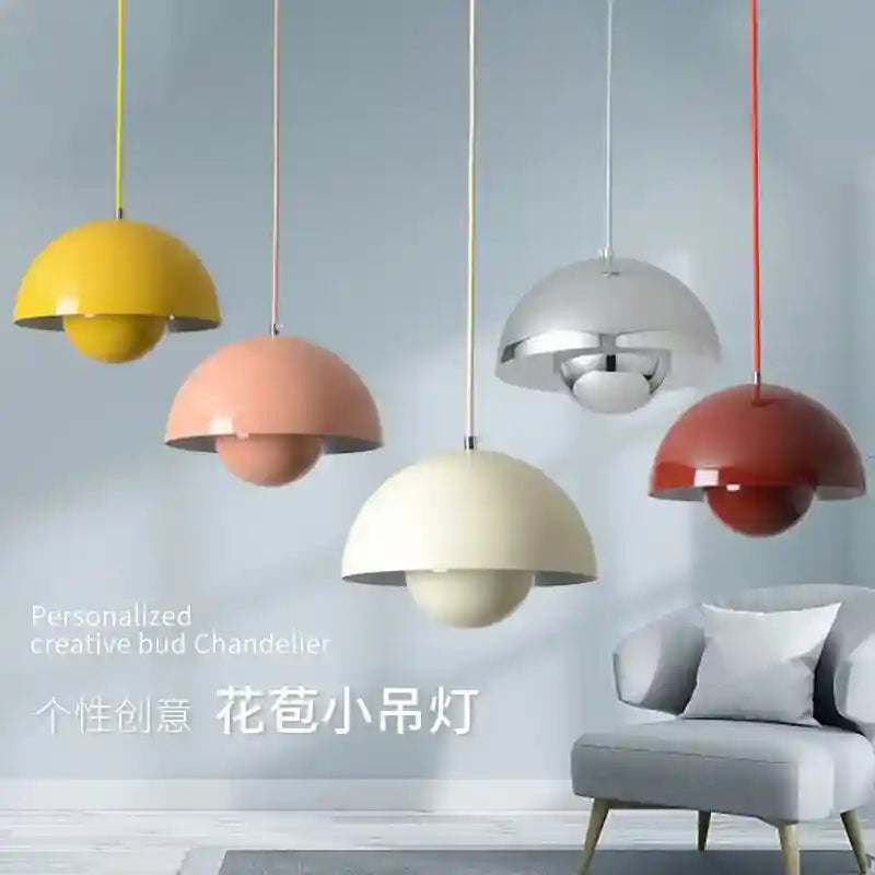 Colorful pendant lights hanging above a gray sofa with a light gray wall background.