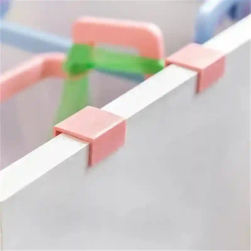 Colorful plastic clips on a white surface