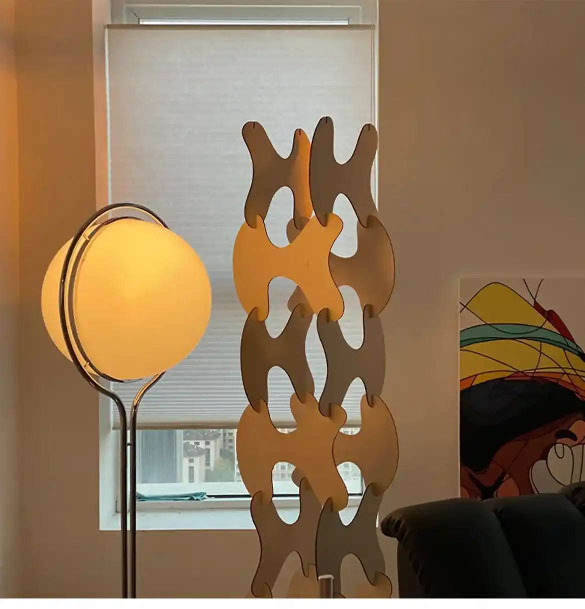 Decorative room divider with a lamp and window in the background