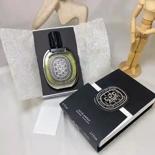 Diptyque perfume bottle and packaging on a white background
