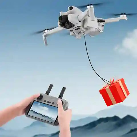 Drone delivering a gift with a controller in the foreground against a blue sky.