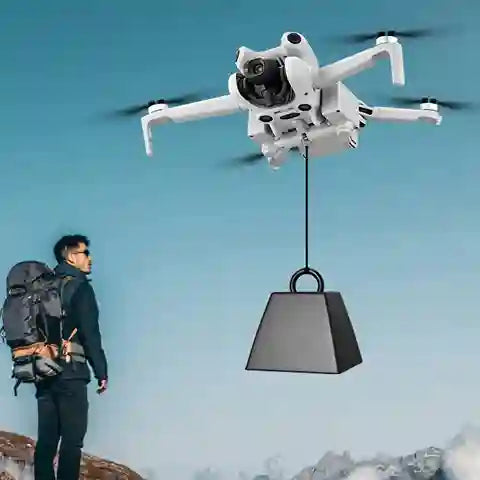 Drone lifting a bell with a person watching from below against a blue sky.