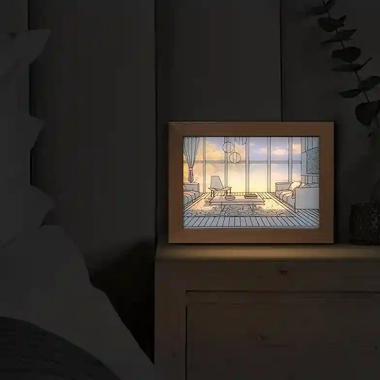 Framed artwork of a living room scene on a dark surface