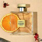 Gabelil Chavnk perfume bottle with an orange slice on a beige background