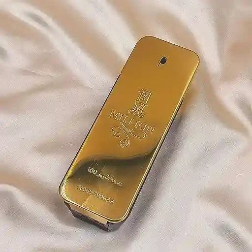 Gold perfume bottle with '1 Million' branding on a light fabric background