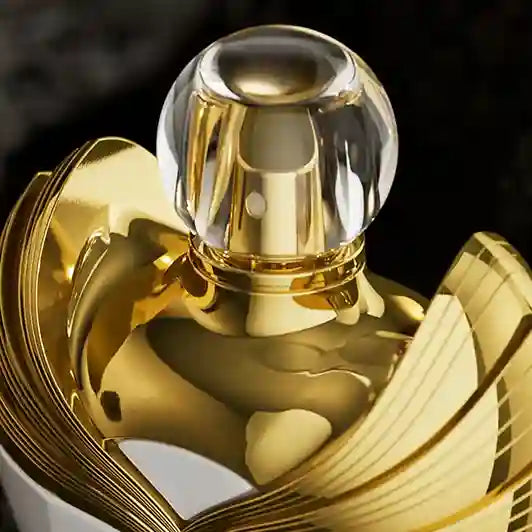Gold perfume bottle with a clear cap on a dark background