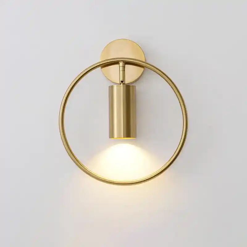 Gold wall-mounted light fixture on a white background