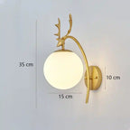 Gold wall lamp with deer antler design and measurements on a light gray background