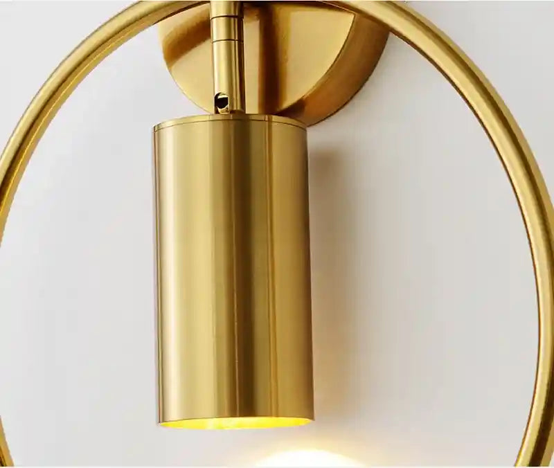 Gold wall sconce on a white background