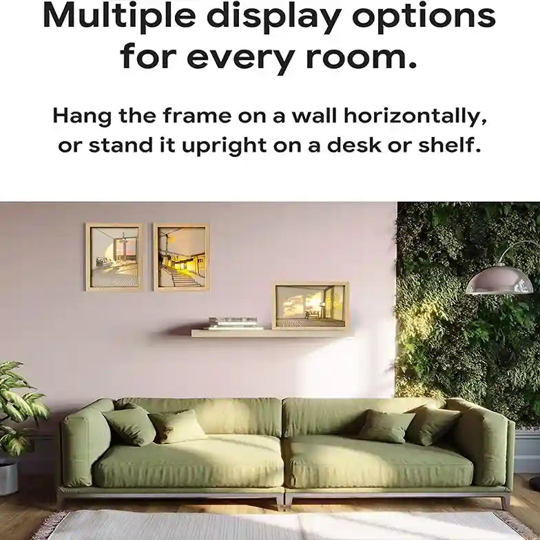 Green sectional sofa in a living room with wall art and a plant.
