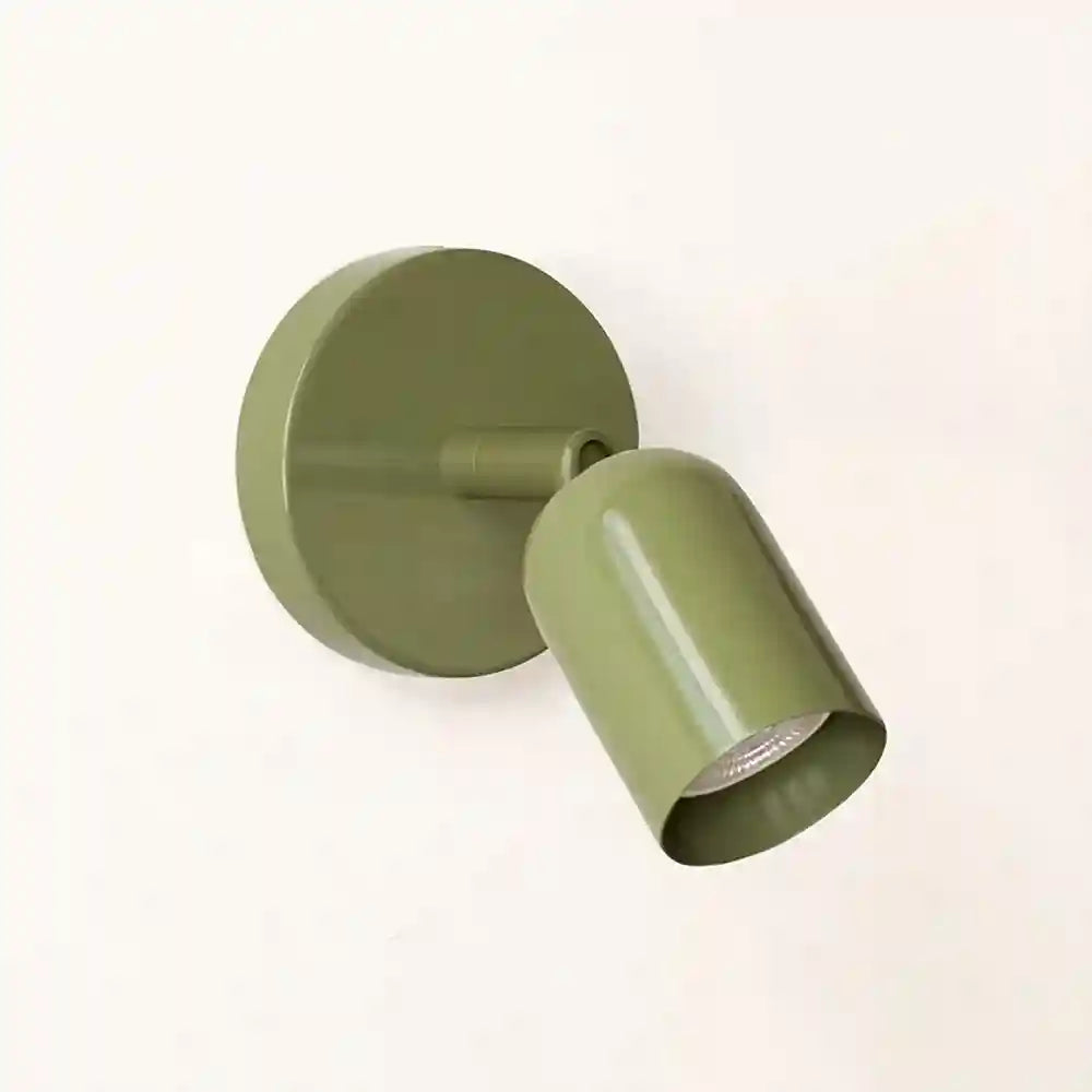 Green wall-mounted light fixture on a white background