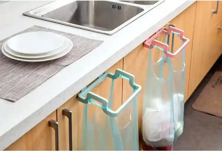 Kitchen counter with a bag holder, sink, and cabinets.
