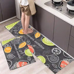 Kitchen floor with patterned mats featuring fruits and text, person stepping onto one of them.