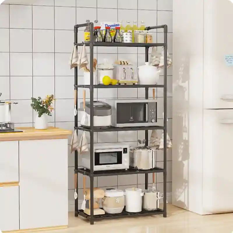 Kitchen shelf with appliances and items against a tiled wall.
