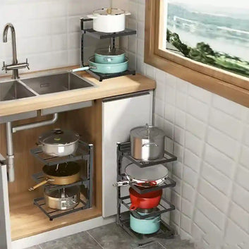 Kitchen storage solution with pots and pans on shelves next to a window.
