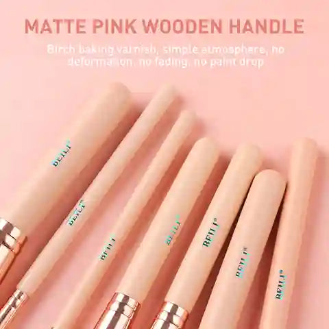 Makeup brushes with matte pink wooden handles on a pink background
