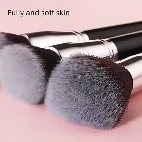 Makeup brushes with soft bristles on a pink background