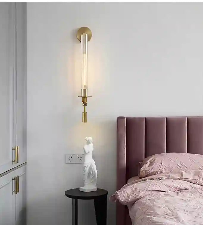 Modern bedroom with a bed, nightstand, and wall sconce.