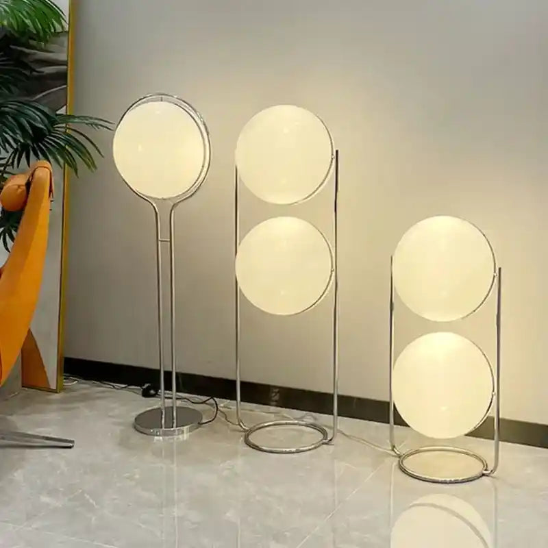 Modern floor lamps with spherical designs on a light-colored floor.