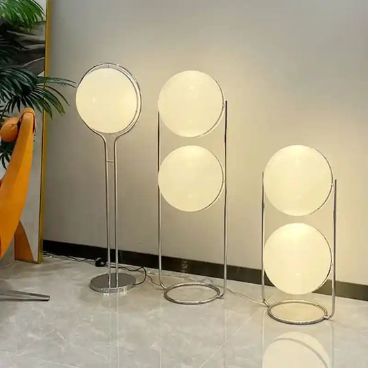 Modern floor lamps with spherical designs on a light-colored floor.