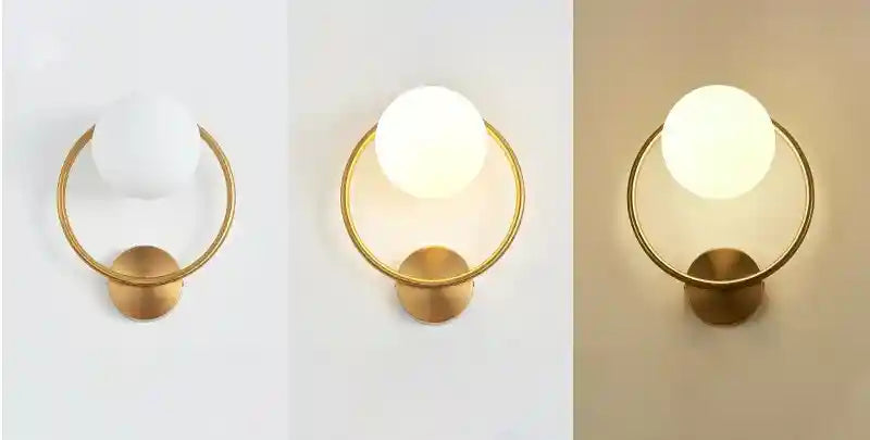 Modern gold table lamp with a white bulb on a neutral background