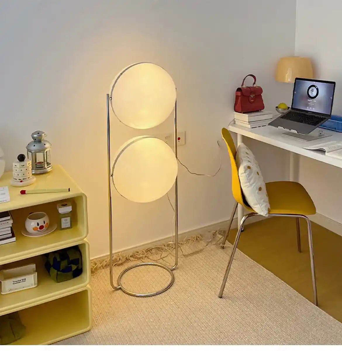 Modern home office with a floor lamp, desk, and chair.