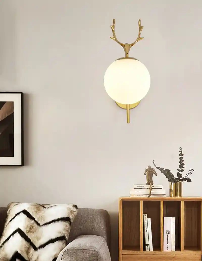 Modern living room with a wall-mounted lamp, sofa, and bookshelf.