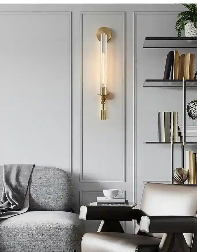 Modern living room with gray sofa, white chair, and wall sconce.
