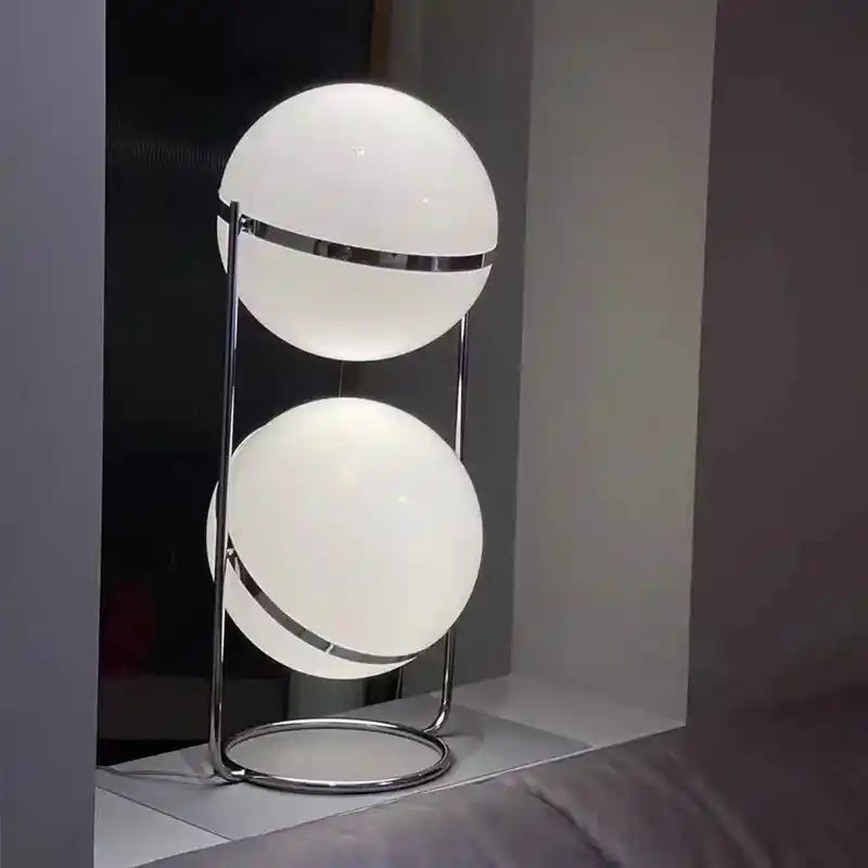 Modern table lamp with two spherical shades on a dark background