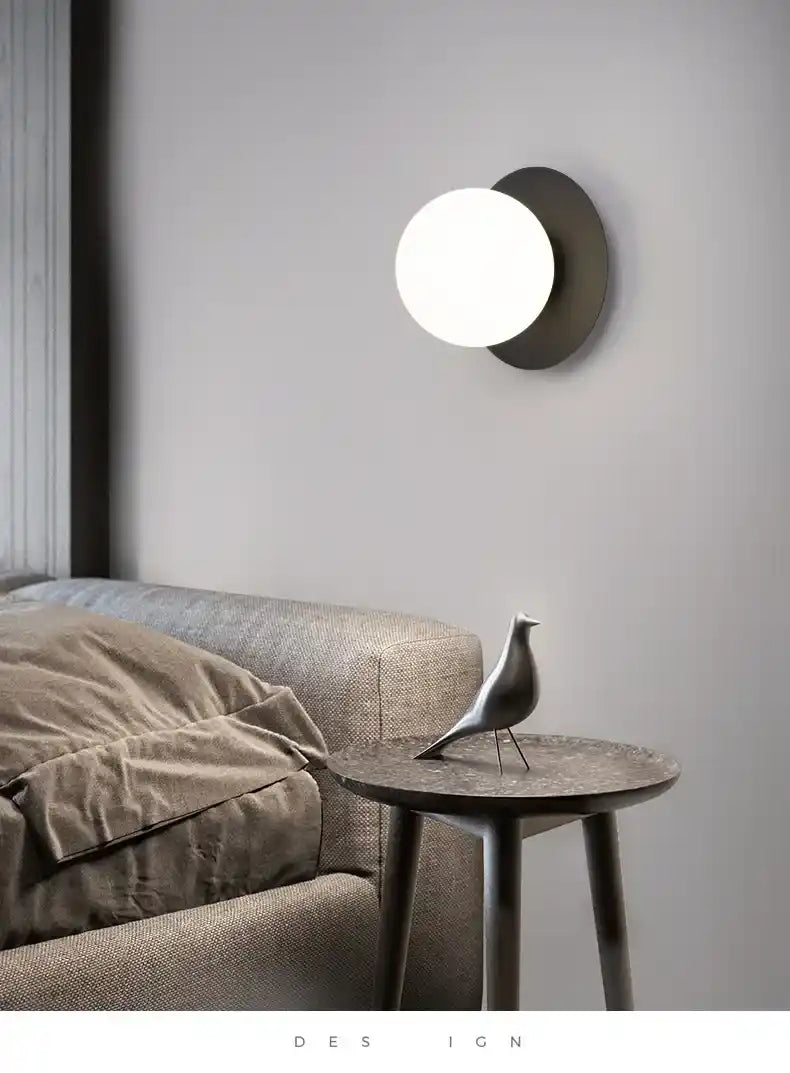 Modern wall lamp above a sofa in a living room setting