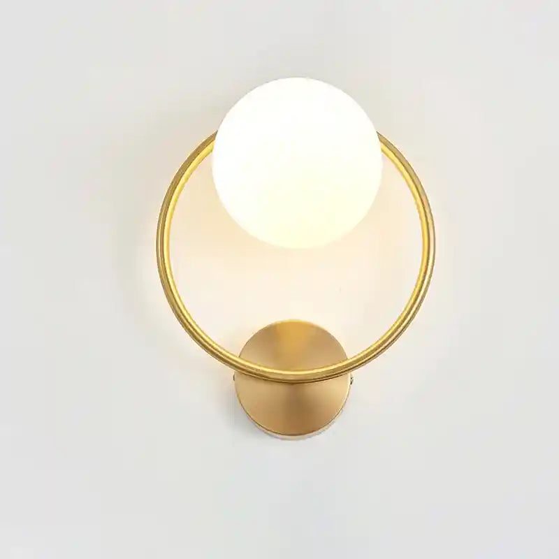 Modern wall light fixture with a gold finish on a white background
