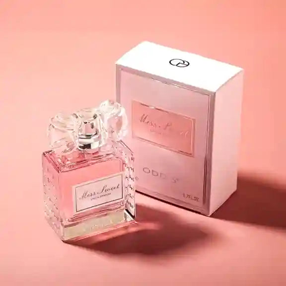 Perfume bottle and packaging on a pink background