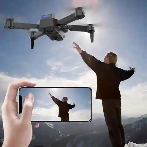Person controlling a drone with a smartphone showing a live feed of themselves