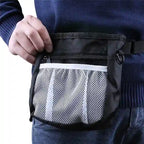 Person wearing a black waist bag with a mesh pocket.